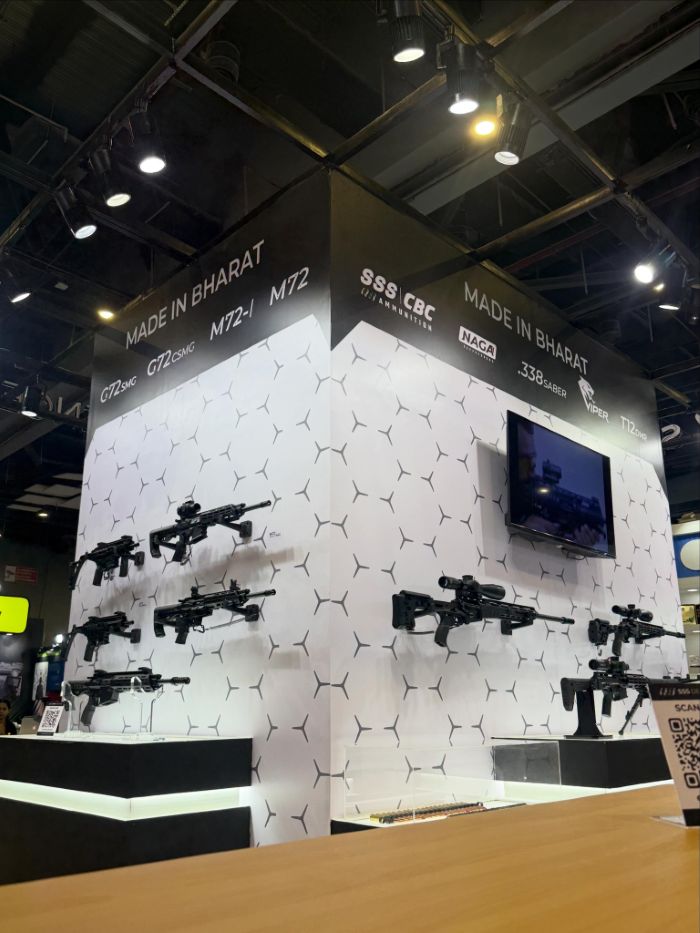 A tall corner tower at Police Expo 2026, its white hexagon walls hung with rifles under a black header listing G72, M72, .338 Saber, Viper and T12