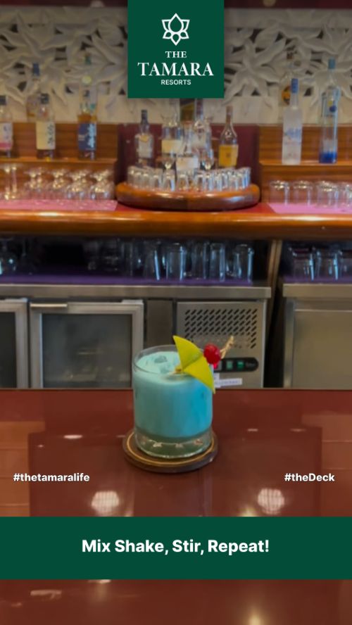Vertical ad: a blue cocktail on the bar, Mix shake, stir, repeat!